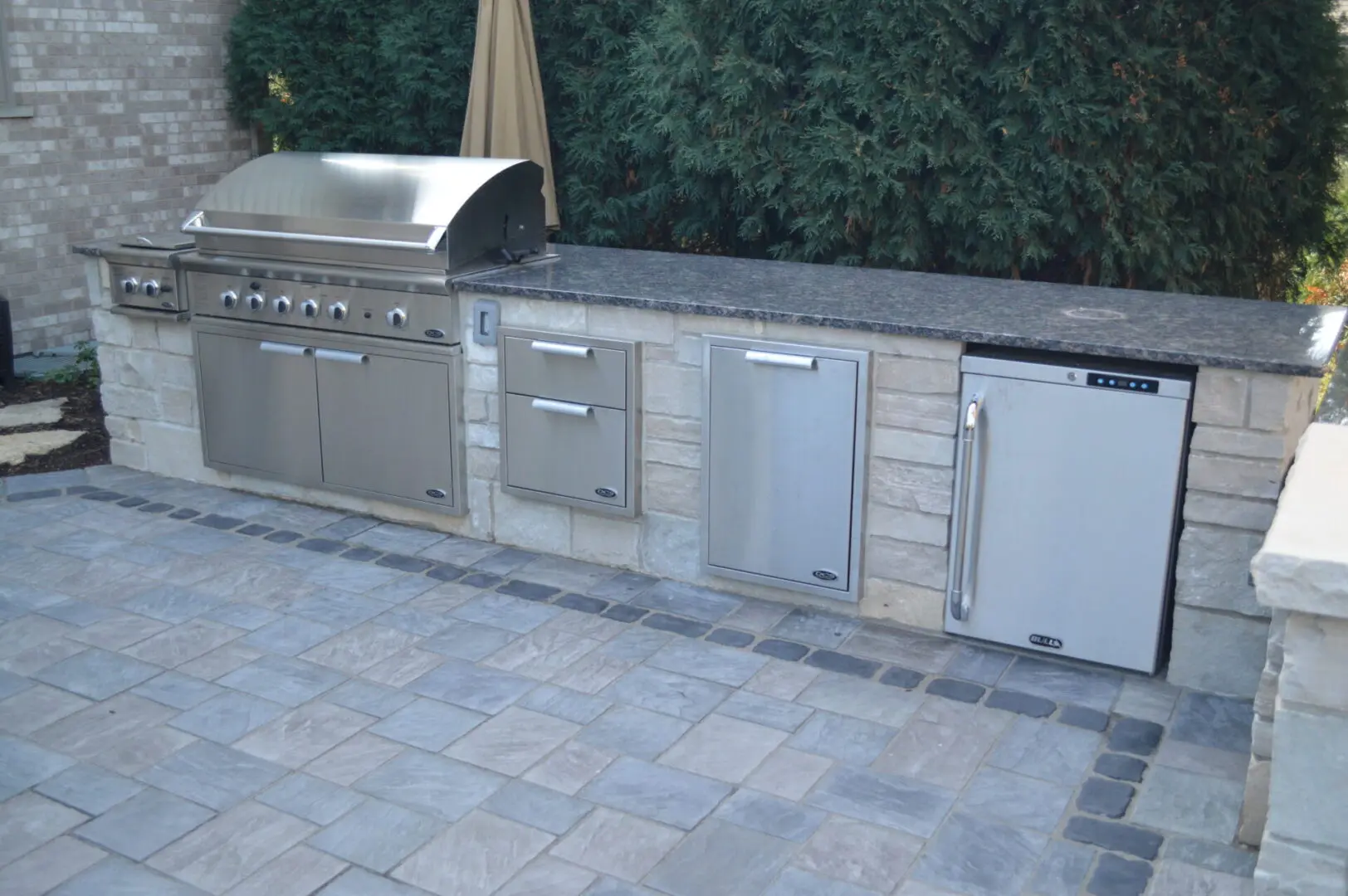 Natural stone grill cabinet with drawers anf refrigerator installation in Western Springs, IL