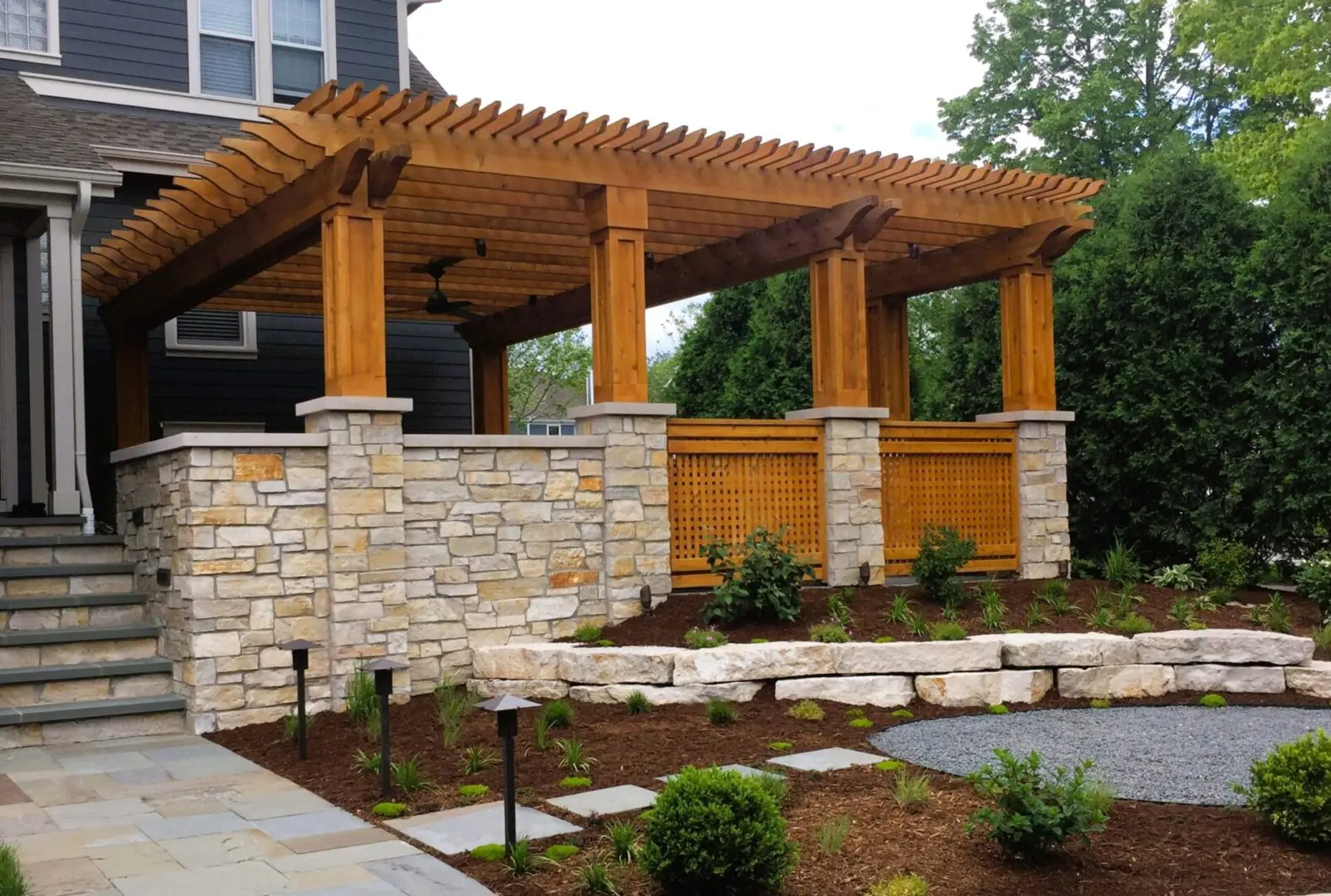 High-end custom cedar pergola and natural stone pillars installation in Downers Grove, IL front yard