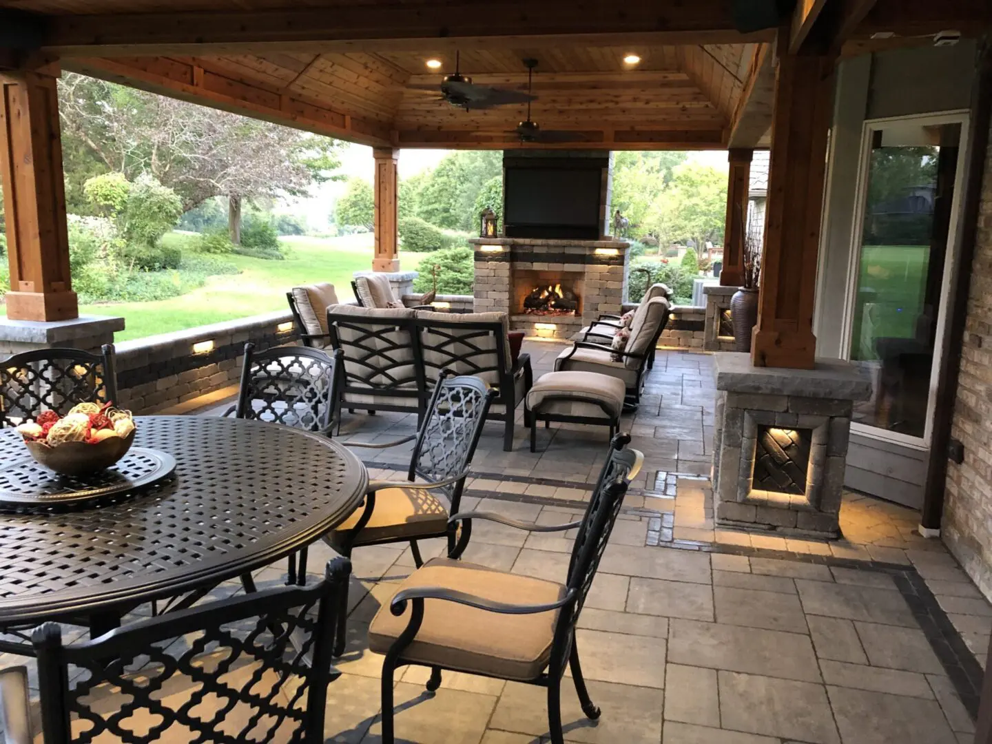 Custom covered patio with chimney and seating wall installation in Glen Ellyn, IL
