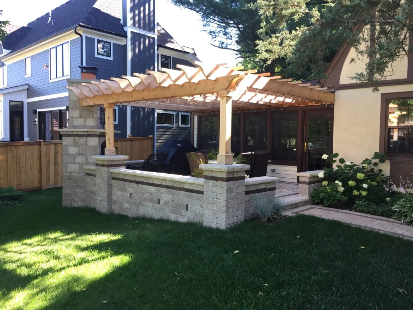 Custom pergola with stone fireplace and pillar installation in Hinsdale, IL
