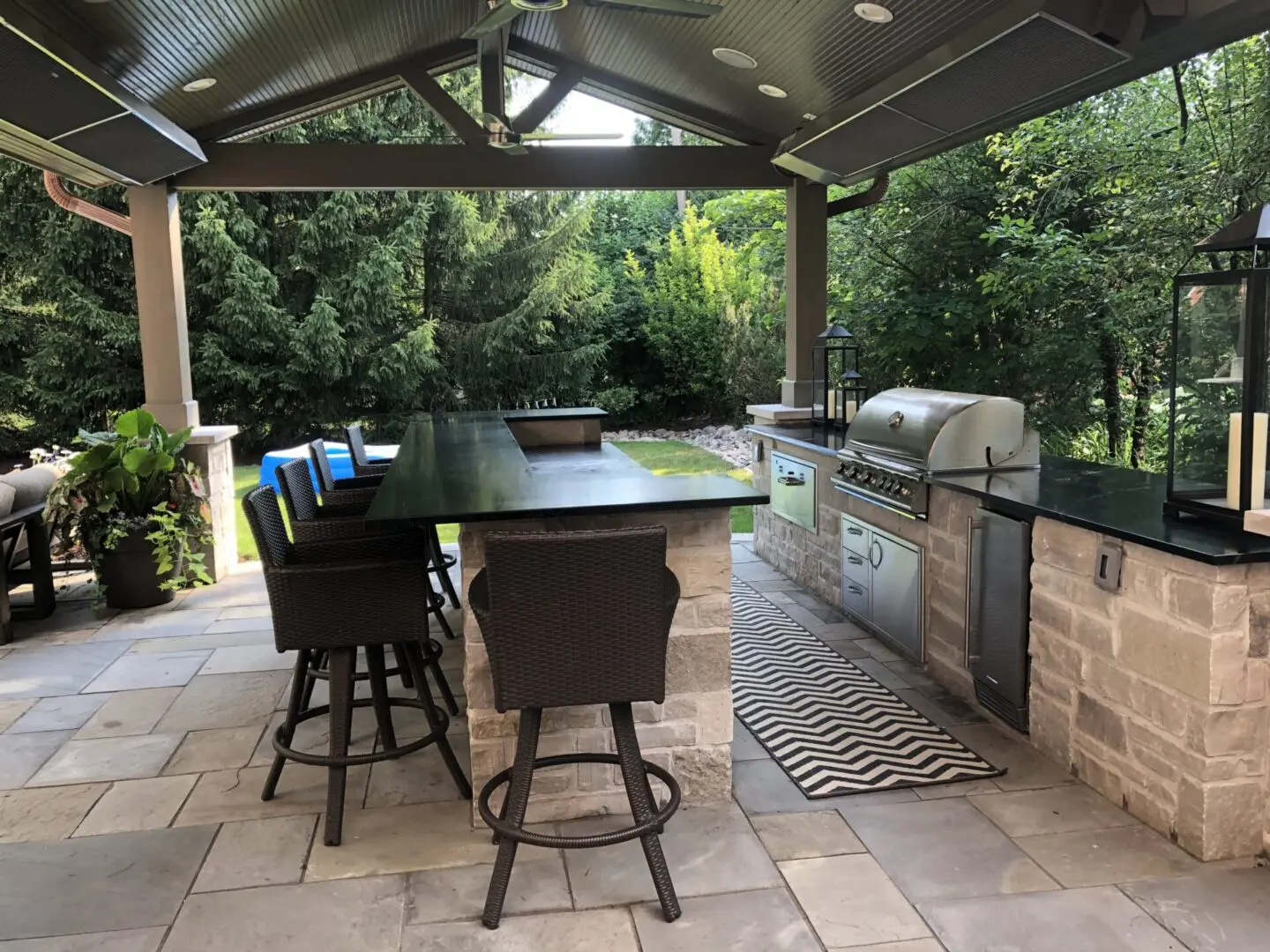 Luxury heated outdoor living space with fans, speakers, bar and outdoor kitchen installation in Hinsdale, IL