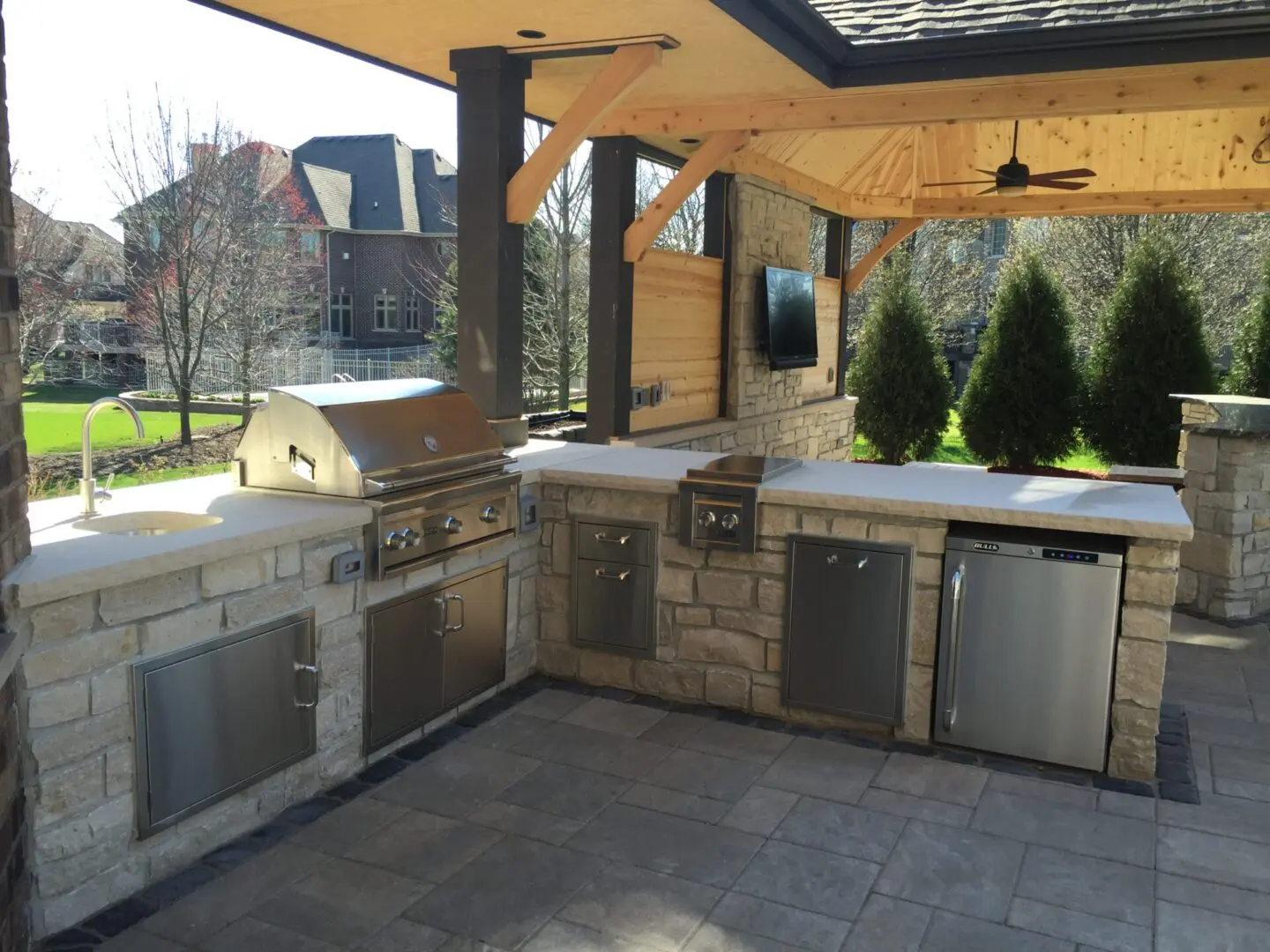 Outdoor kitchen with built-in grill, mini fridge, and cabinet installation in Lemont, IL