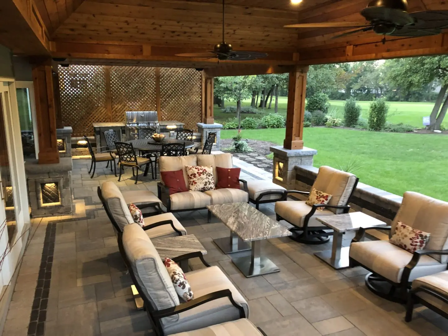 Pavilion and pergola structure in backyard outdoor living space with outdoor kitchen and lighting in Naperville, IL