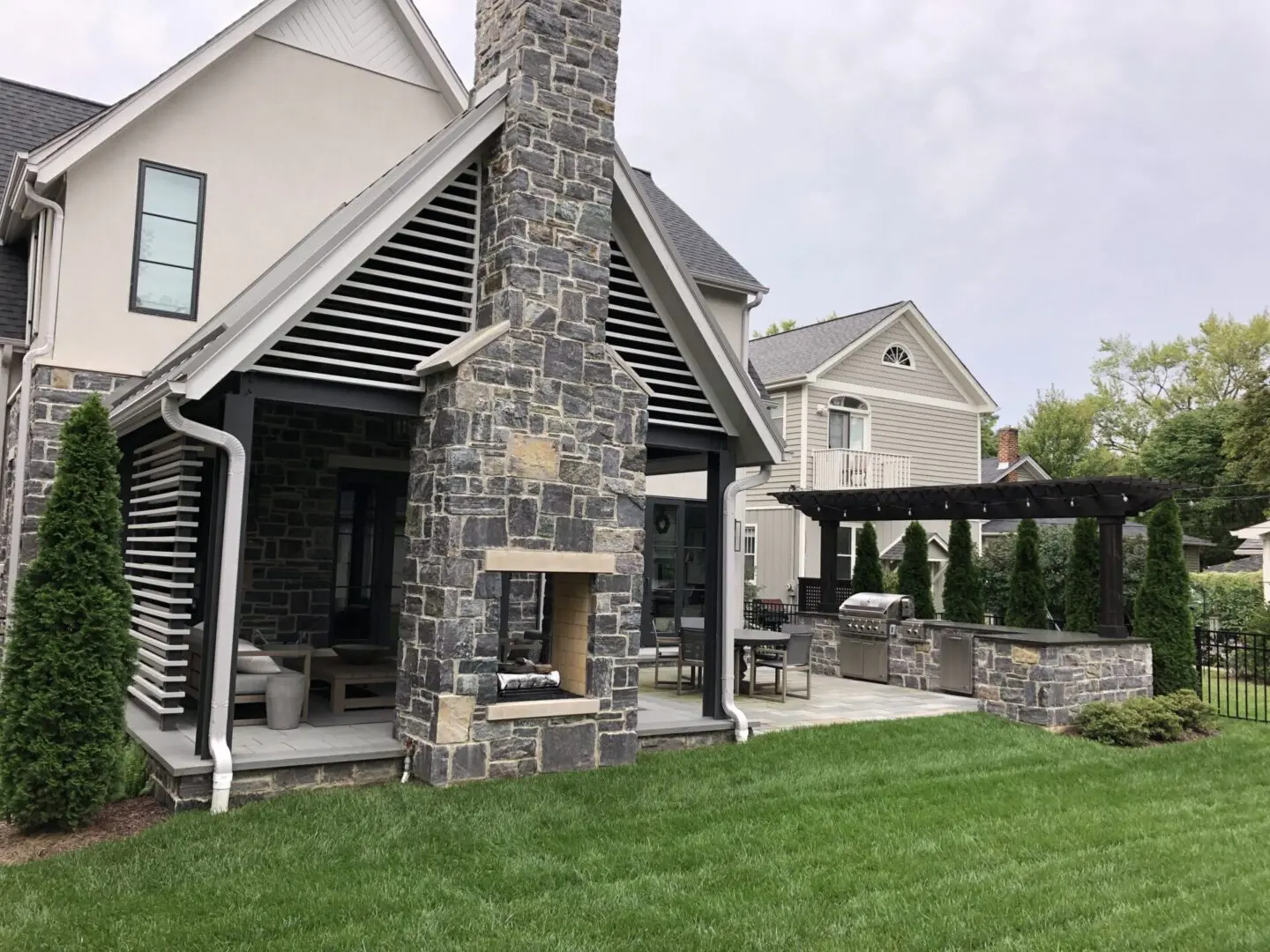 Natural stone patio with custom fireplace and pavilion in Naperville IL