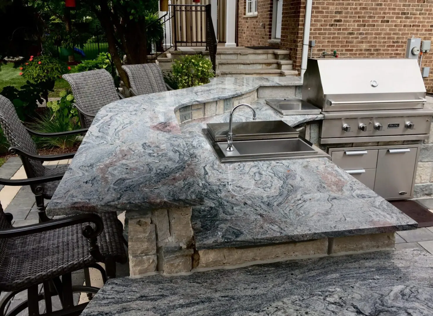Custom outdoor kitchen with bar and grill installation in Hinsdale, IL