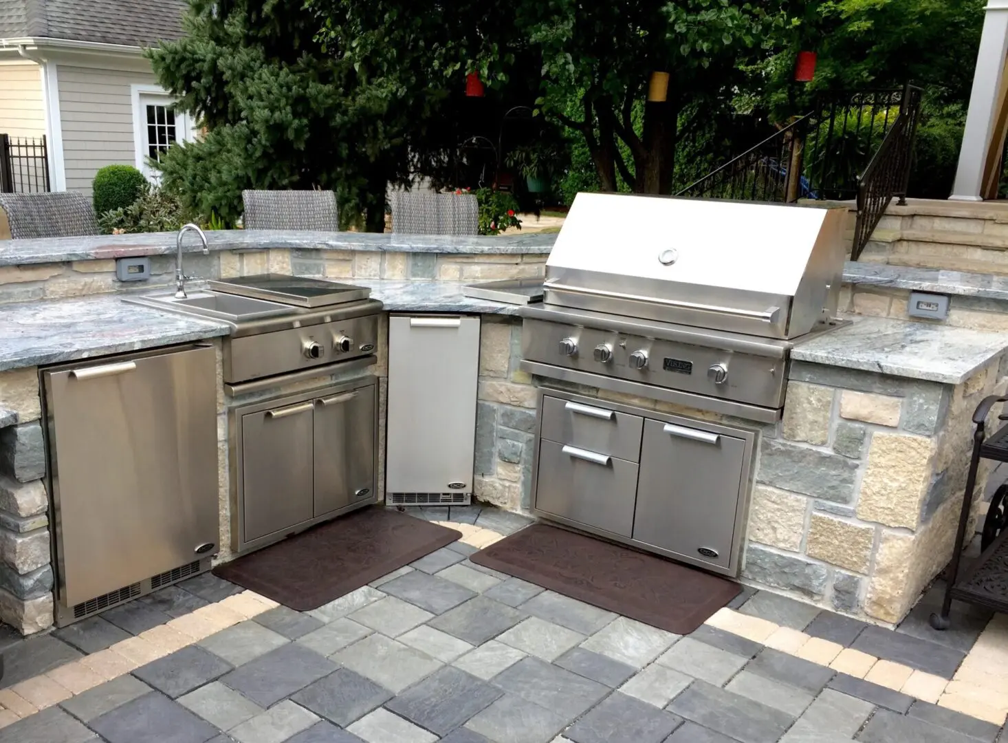 Custom natural stone outdoor kitchen with grill, sink, refrigerator and drawers in Naperville, IL
