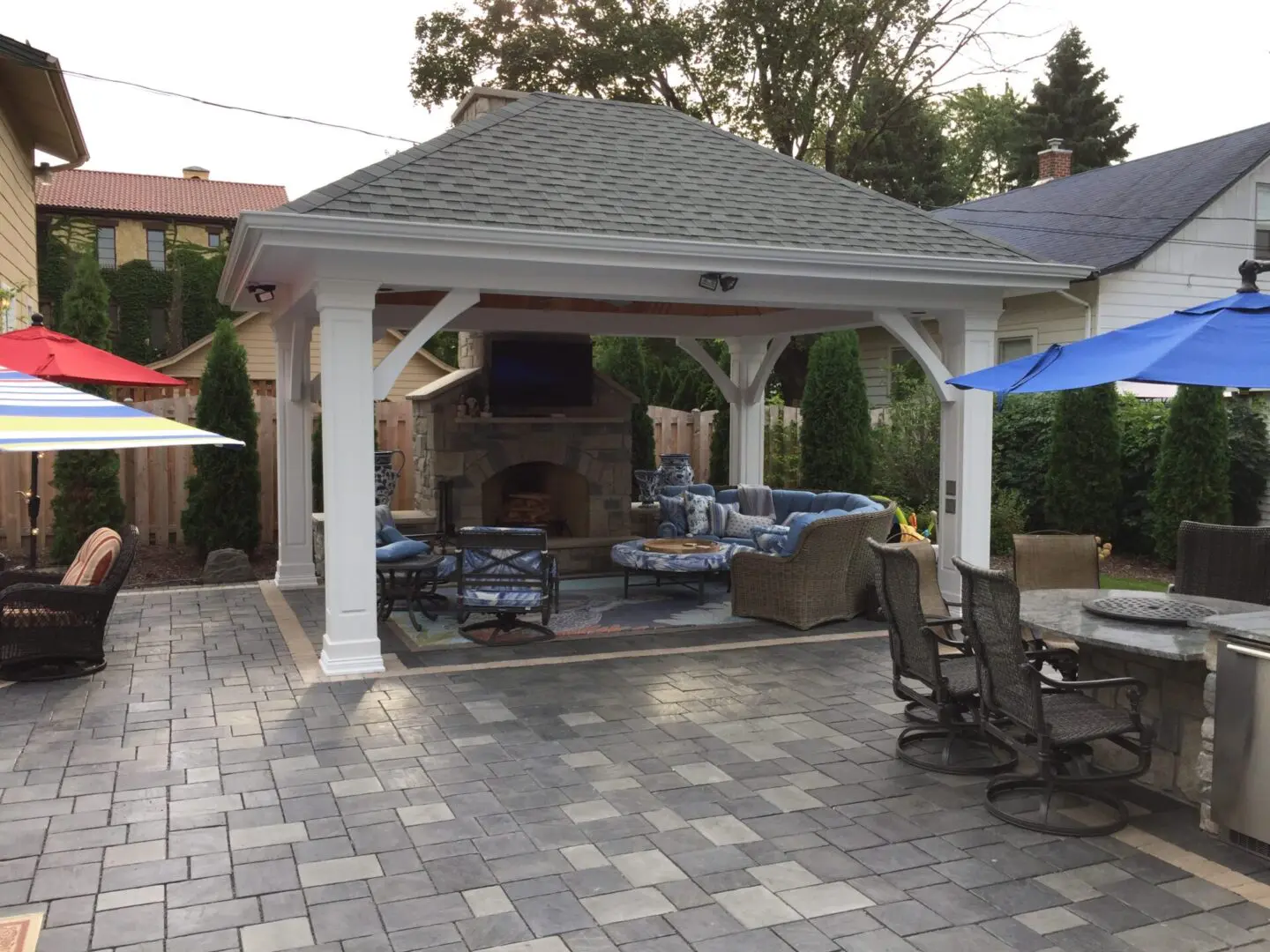 Custom paver patio with bar and roof structure in Naperville, IL backyard