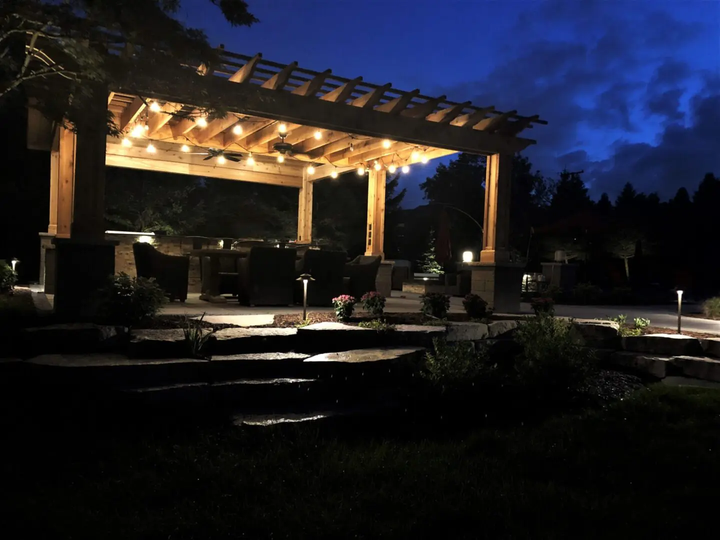 Custom pergola and outdoor living space with landscape lighting installation in Naperville, IL