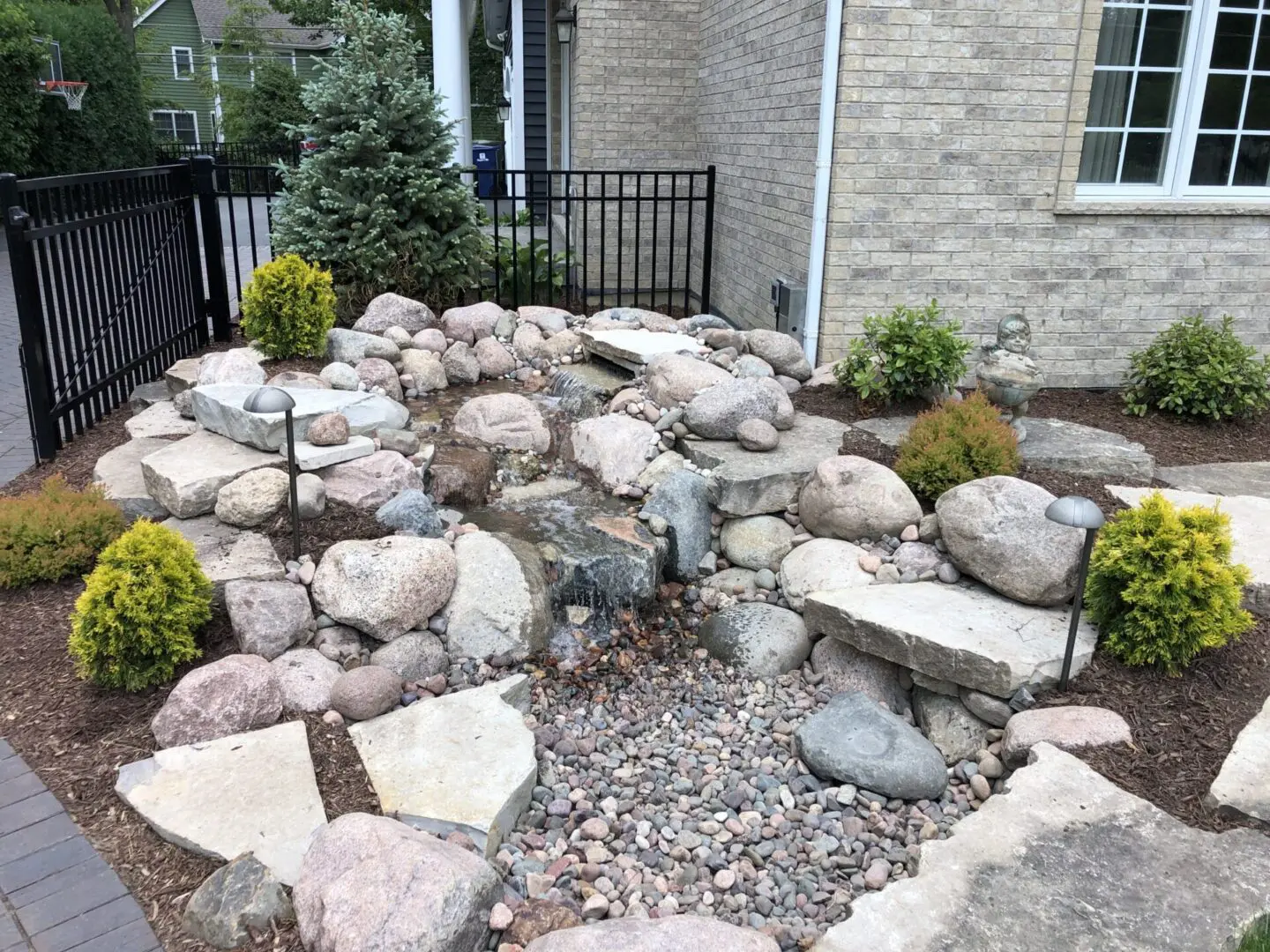Custom pond with waterfall installation in Naperville, IL