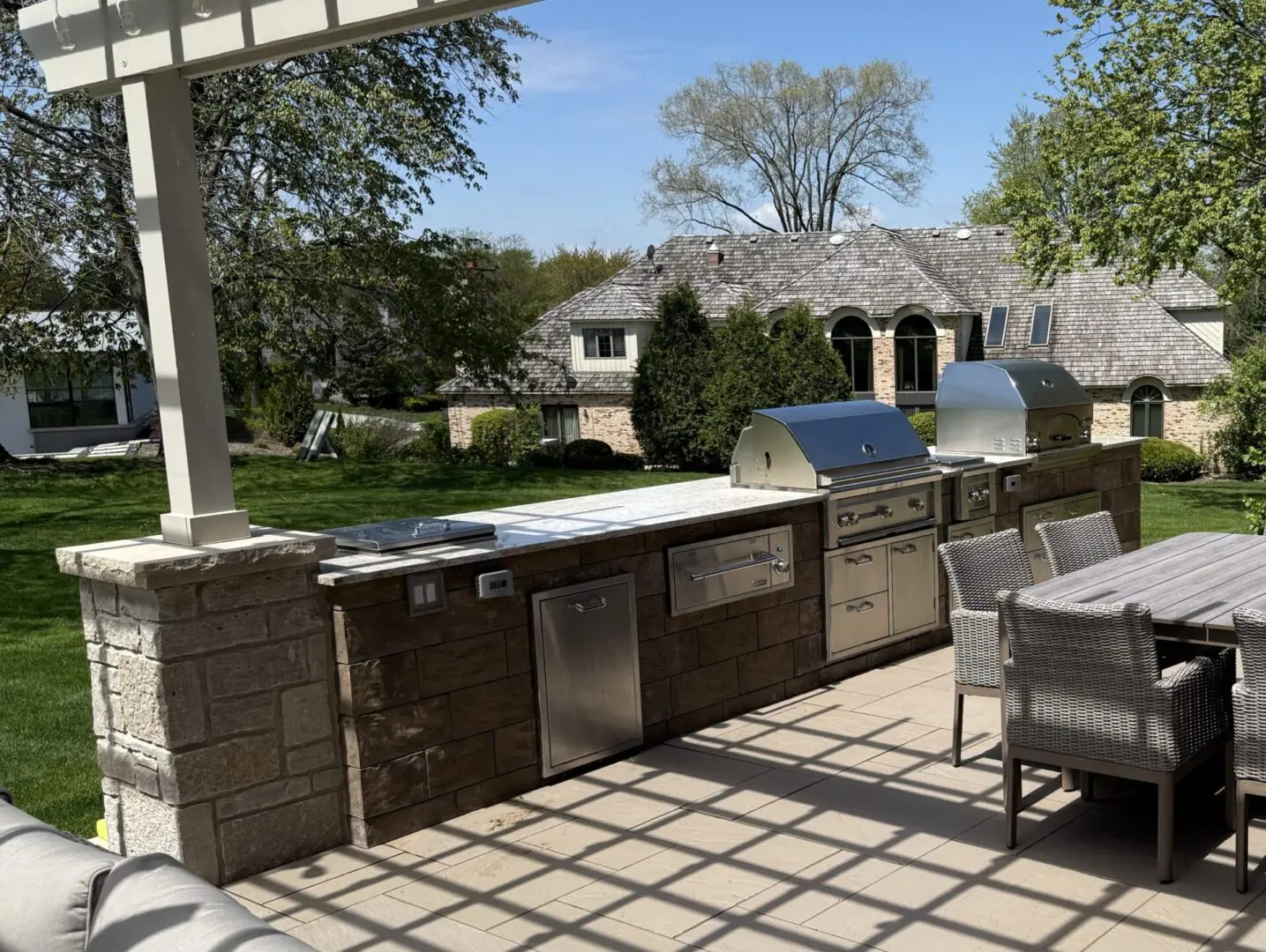 Custom paver patio with pergola and outdoor kitchen installation in Oak Brook, IL