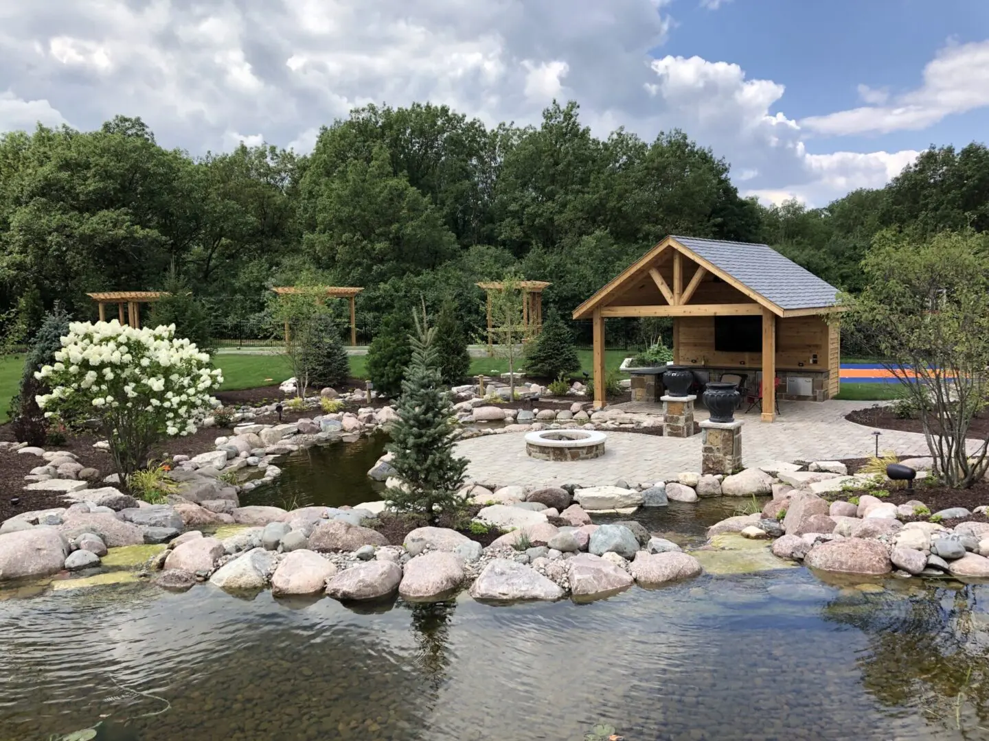 Custom pond and waterfall with landscape design installation in Palos Park, IL