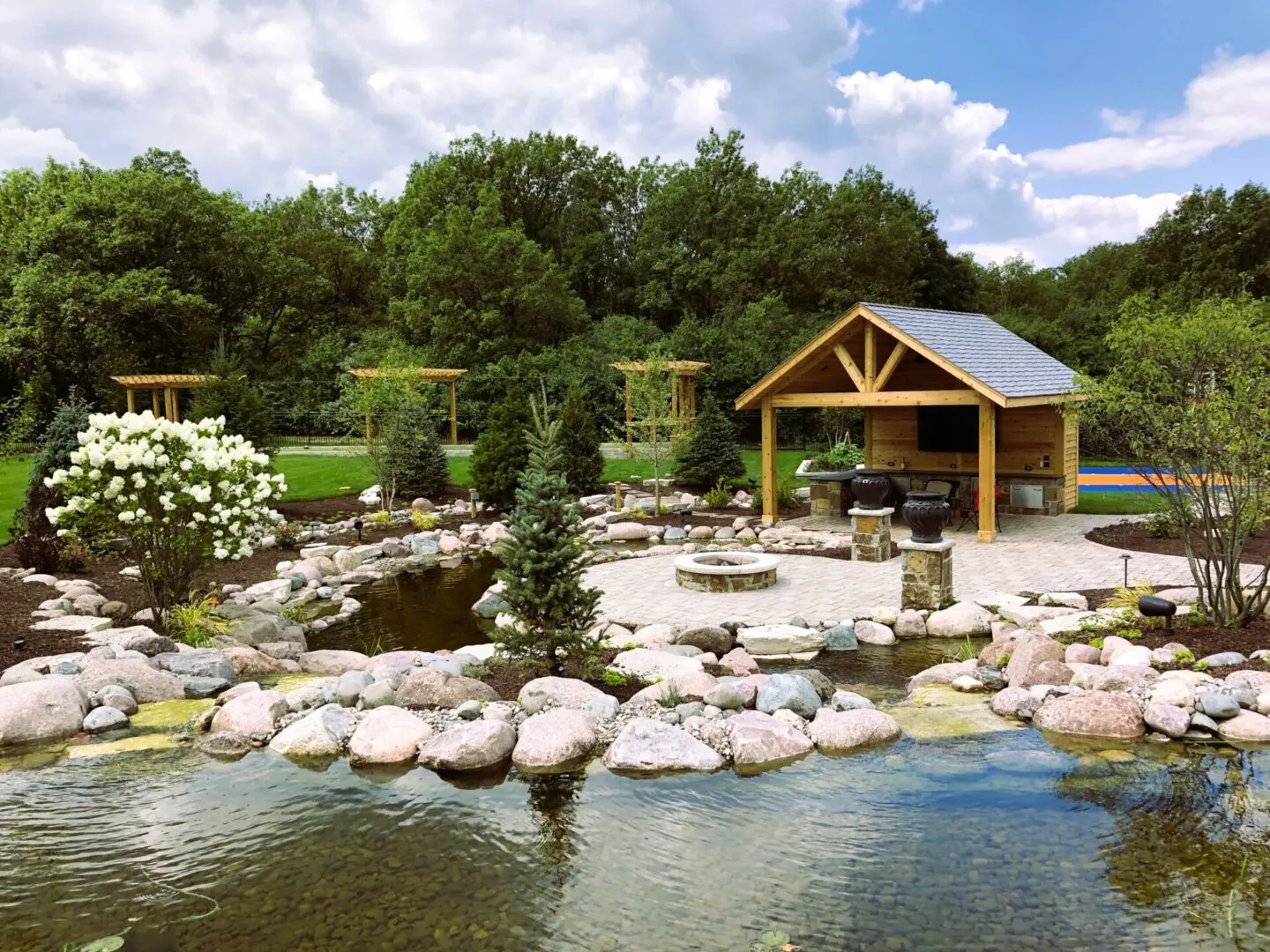 Custom patio and pergola installation with koi pond in Palos Park, IL