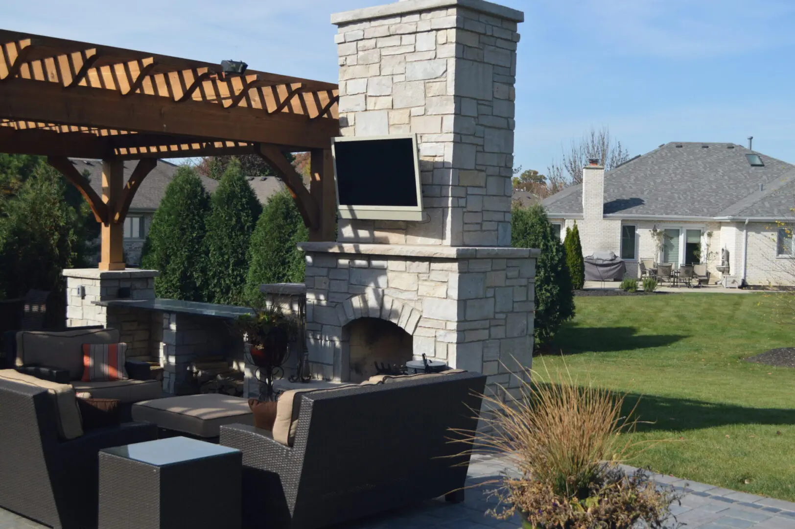 Paver patio with custom fireplace and pergola in Naperville IL
