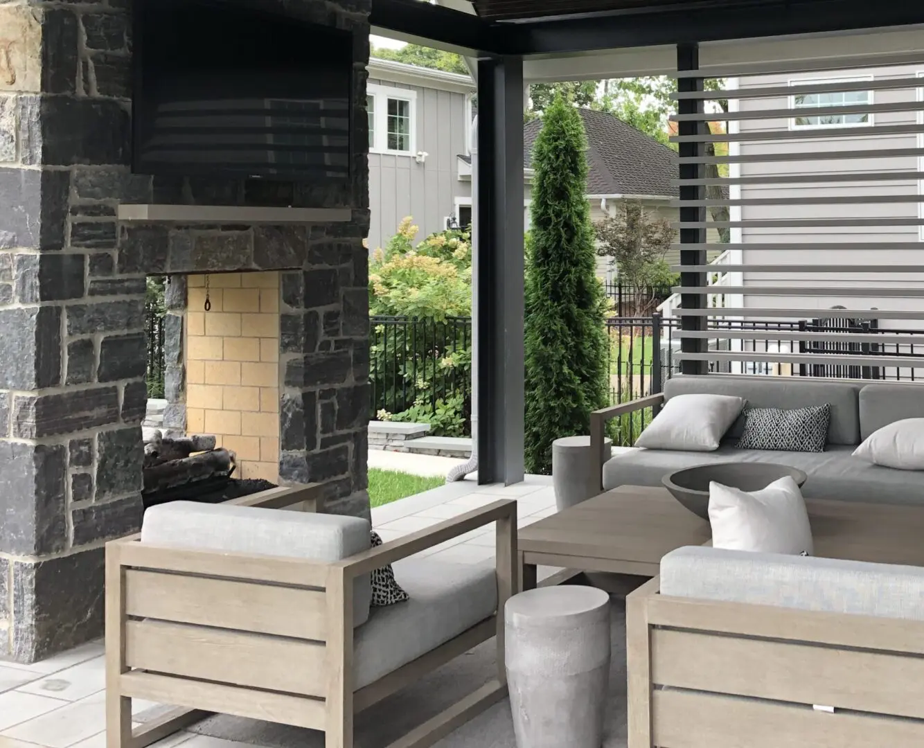 Natural stone patio with custom fireplace and pavilion in Naperville IL