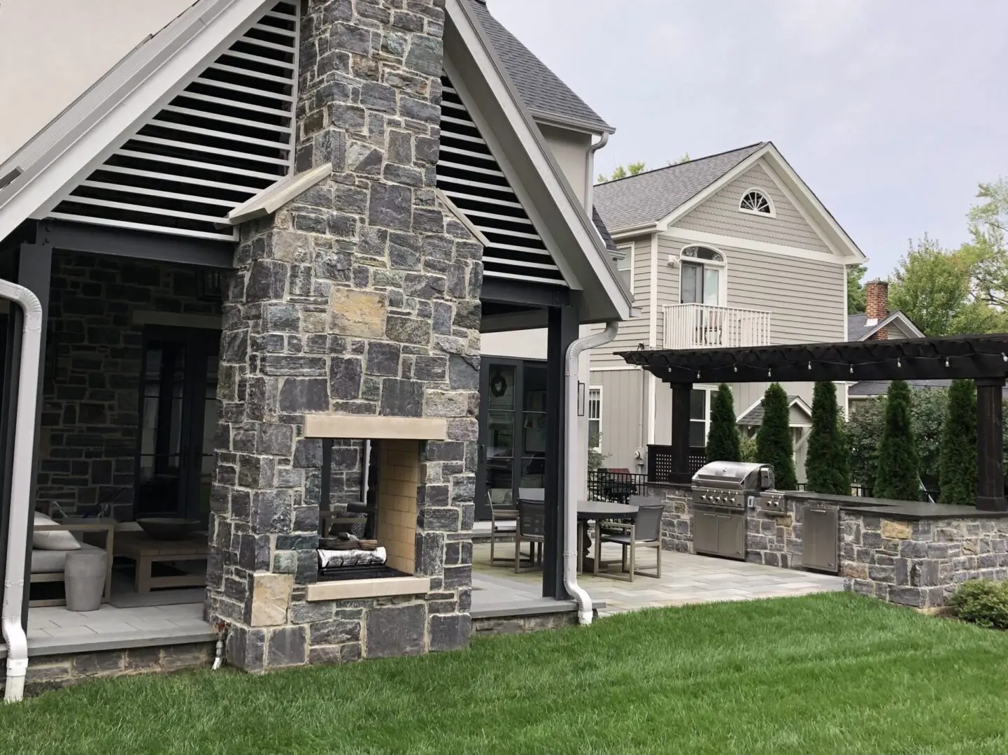 Natural stone patio with custom fireplace and pavilion in Naperville IL