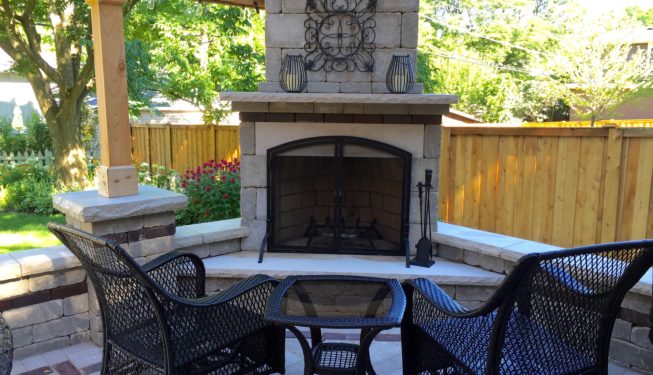 Stone fireplace with black chairs