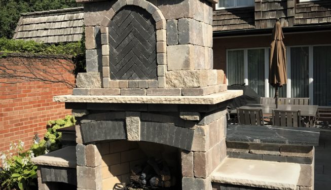 Beige stone fireplace with umbrella