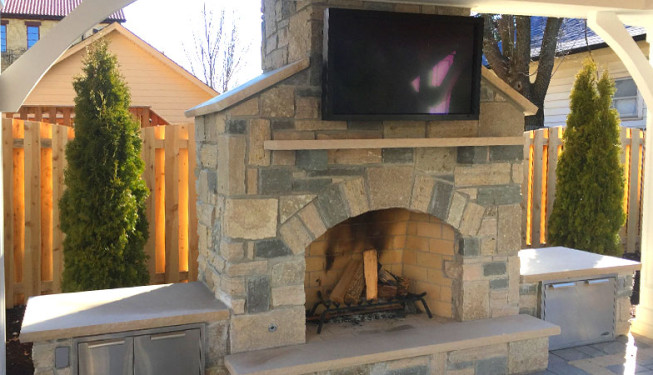 A front view of stone fireplace with firewood storage