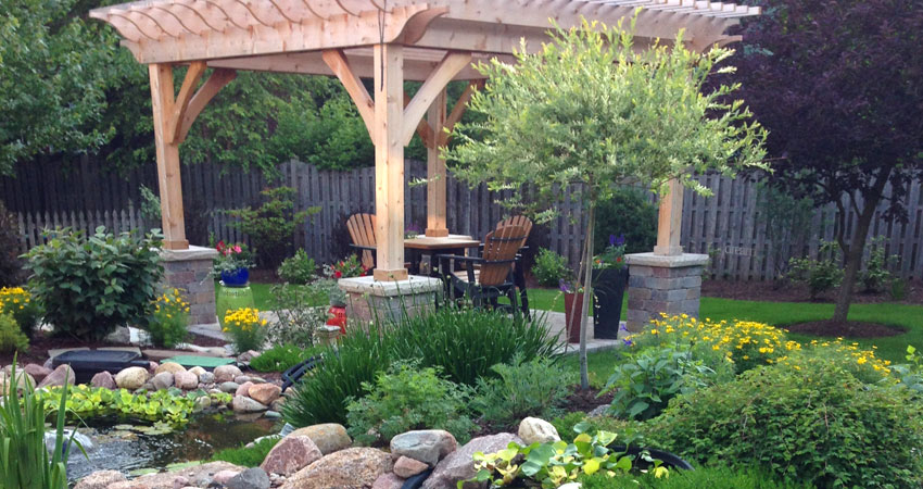 Wooden outdoor area with fountain and plantings