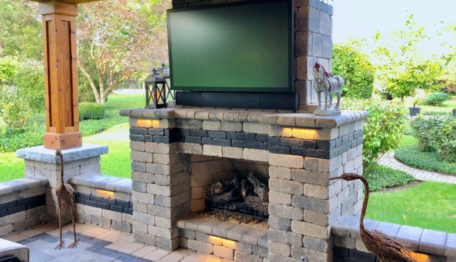 Stone outdoor fireplace with metal flamingoes
