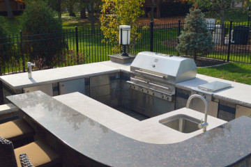 Outdoor kitchen with barbecue unit and sink