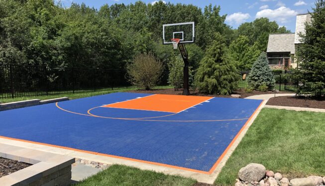 A Basketball Court With Orange and Blue Color Floor